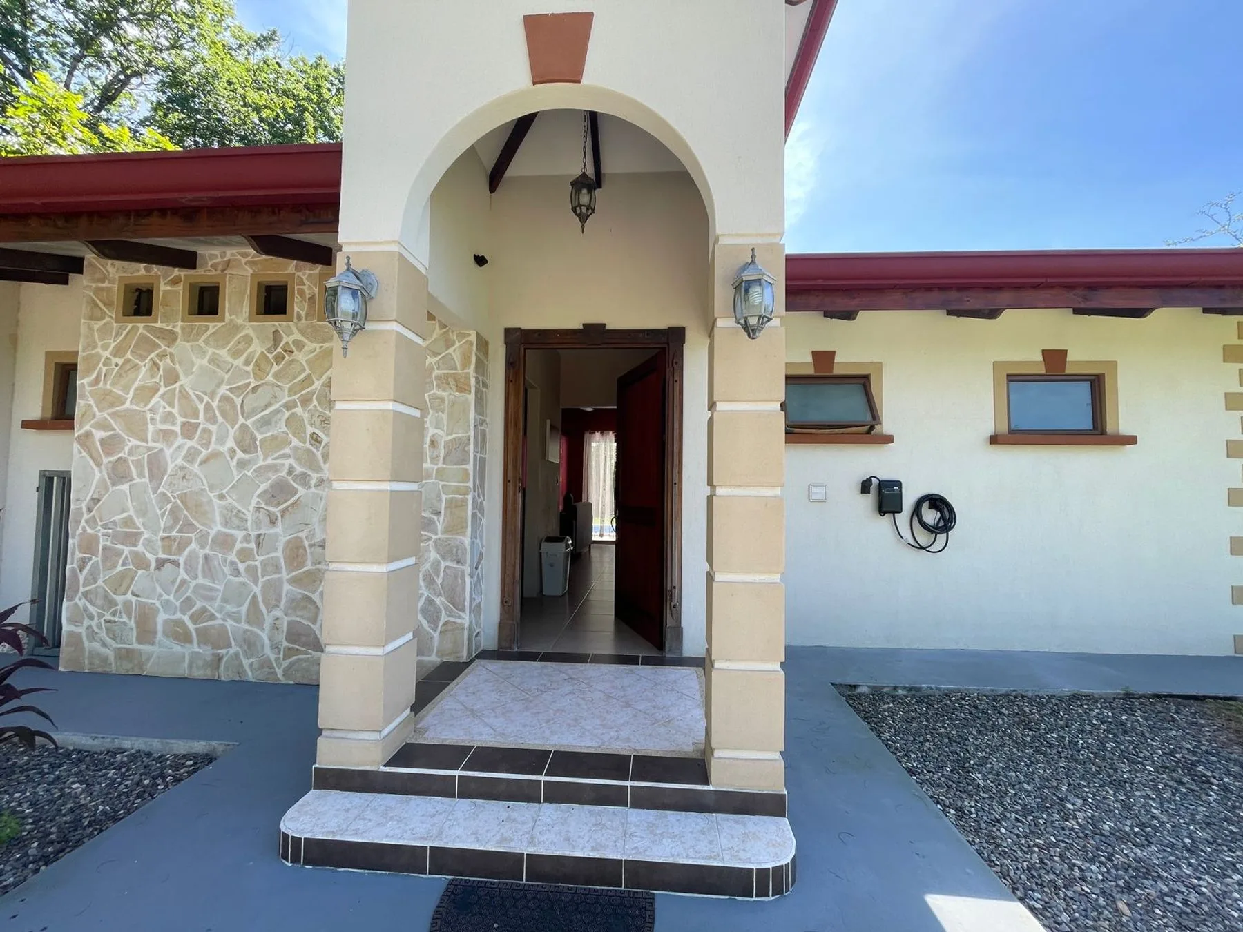 An exterior entrance with an arched doorway and stonework along the facade.
