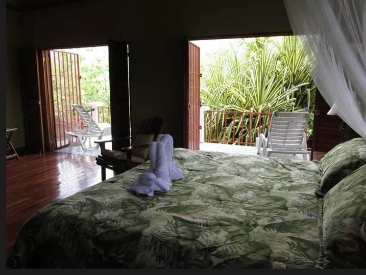 Master bedroom with canopy bed and rainforest view