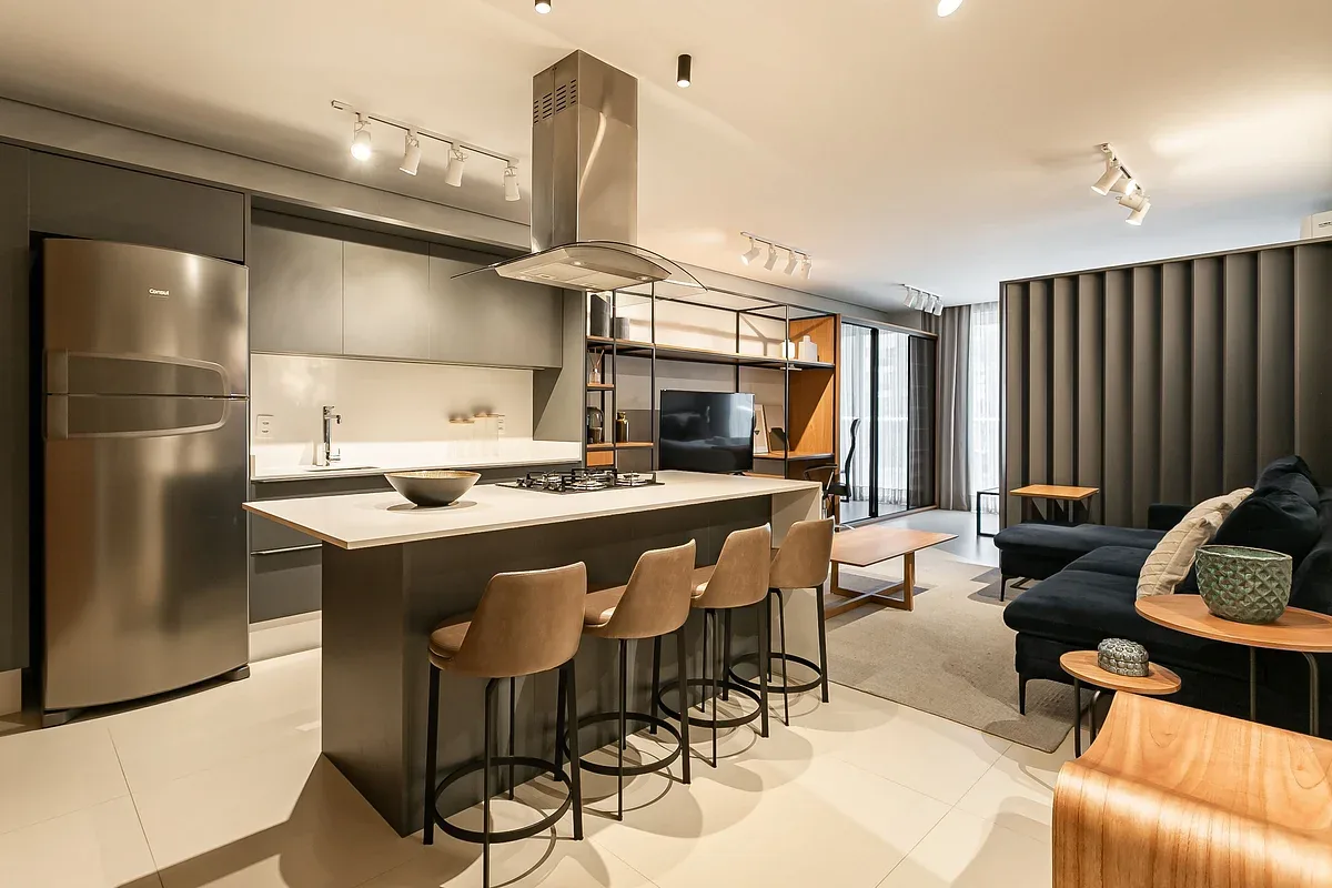 An open-plan kitchen and living area with a counter and seating.