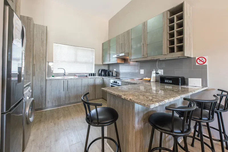 A kitchen with a large island and bar seating.