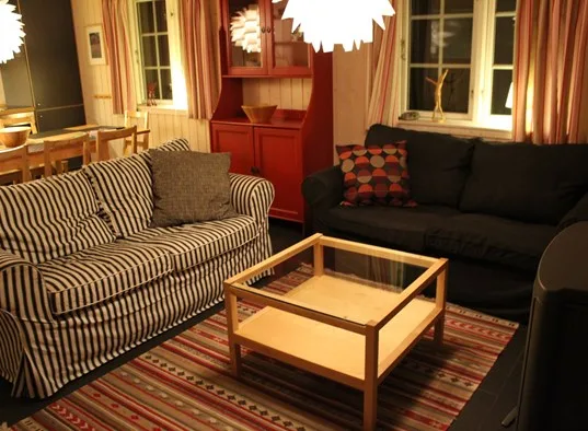A living room with seating around a glass-topped coffee table.