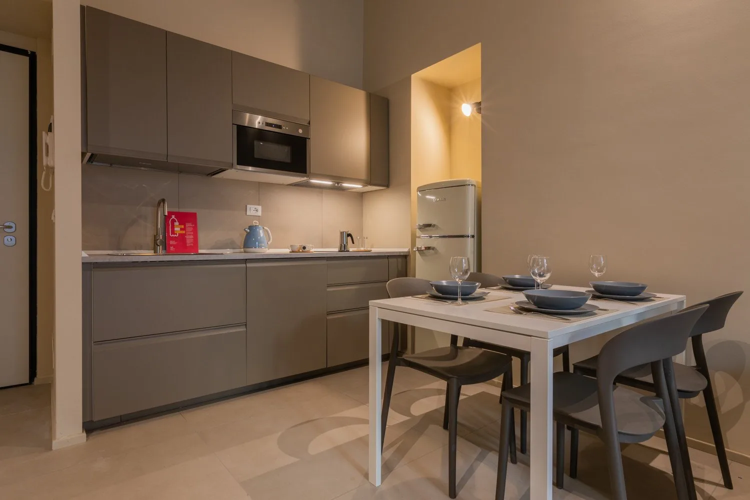 A modern kitchen and dining area with a table set for a meal.