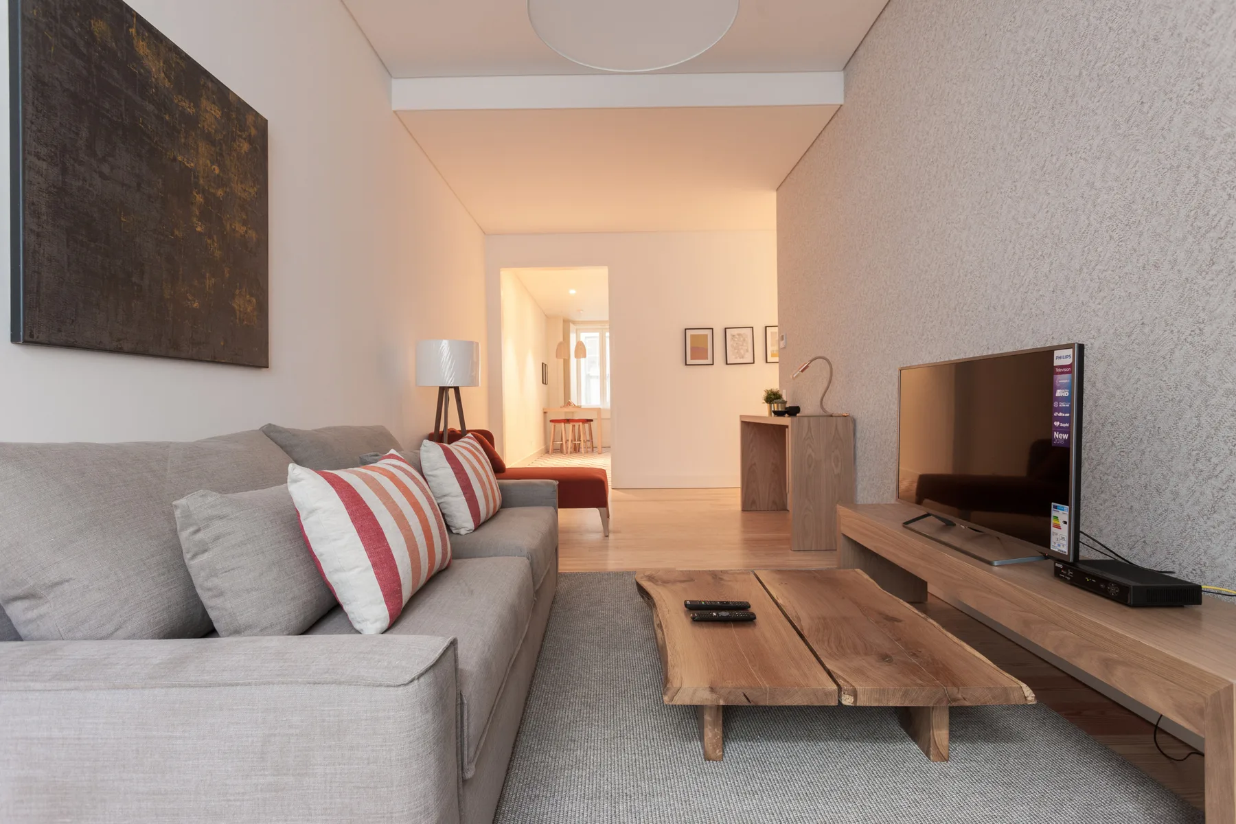 A living room with seating, a coffee table, and a television.
