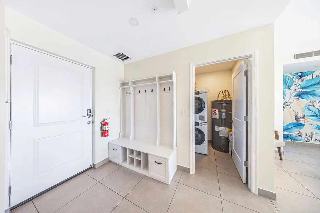 A welcoming entryway greets you with organized cubbies, convenient laundry access, and thoughtfully designed storage spaces to keep your vacation essentials tidy throughout your stay.