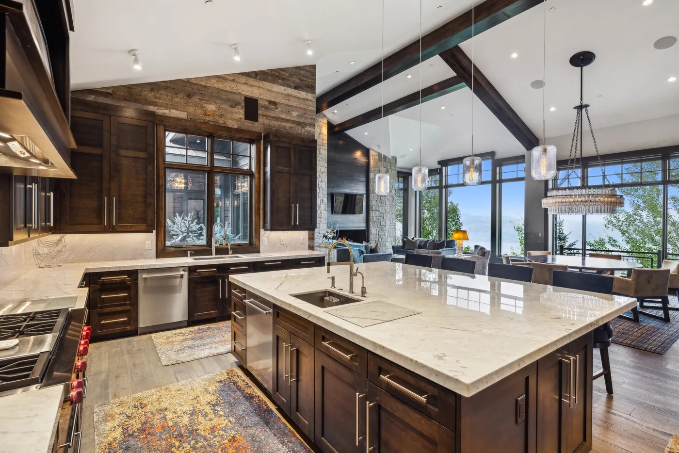 A spacious kitchen with dark cabinetry, a large island, and an adjoining dining area.