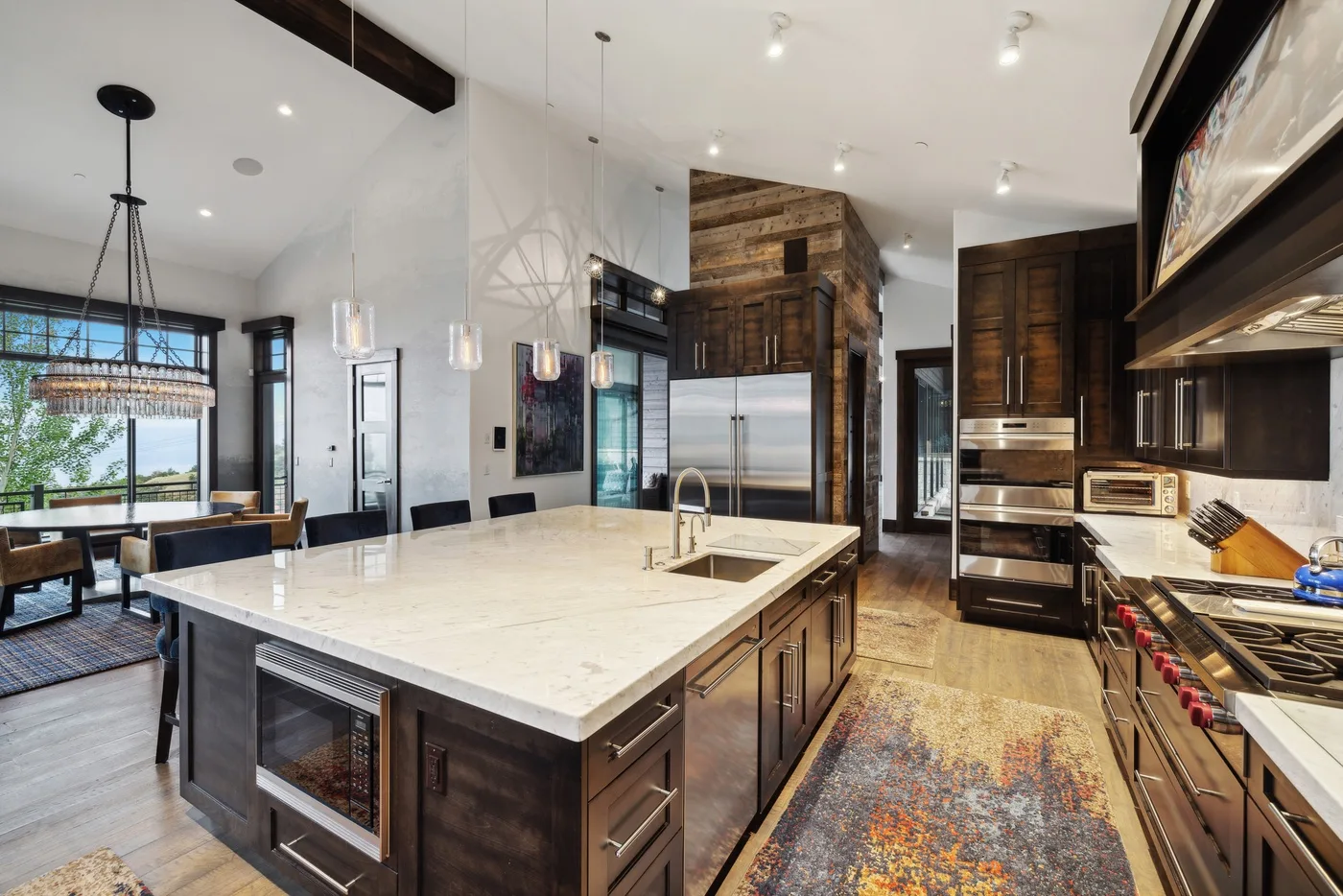A spacious kitchen with a large island and stainless steel appliances.