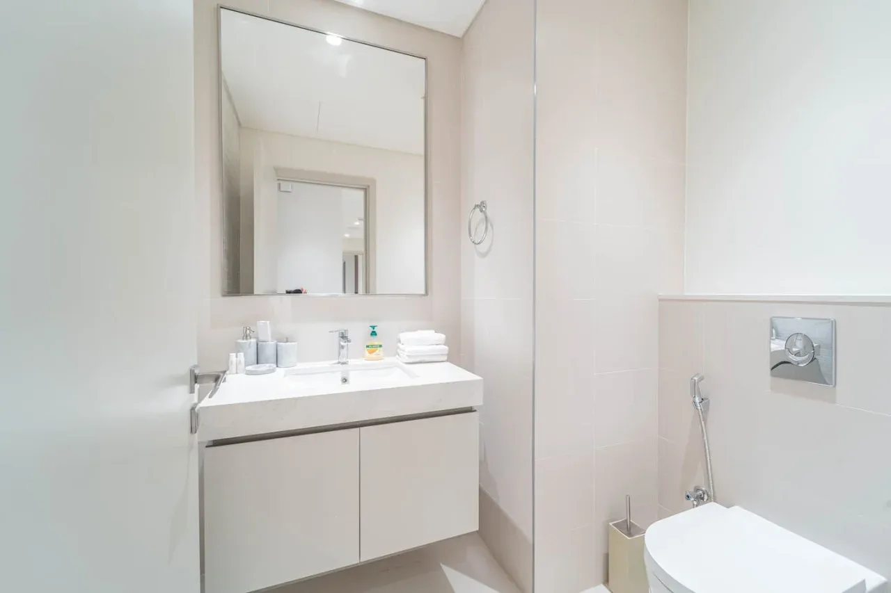 A bright bathroom with a sink vanity and a toilet.