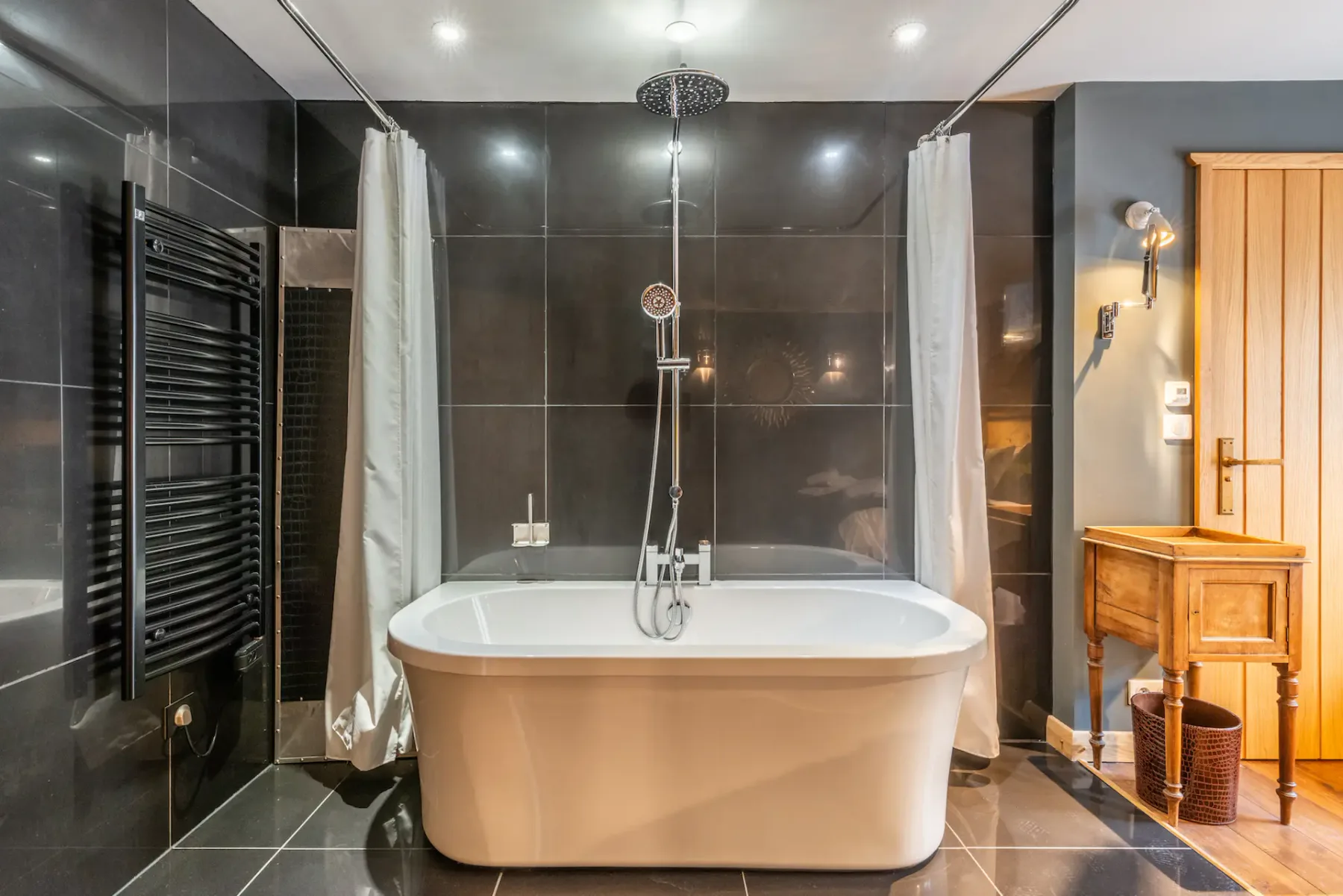 A bathroom with a freestanding bathtub and shower.