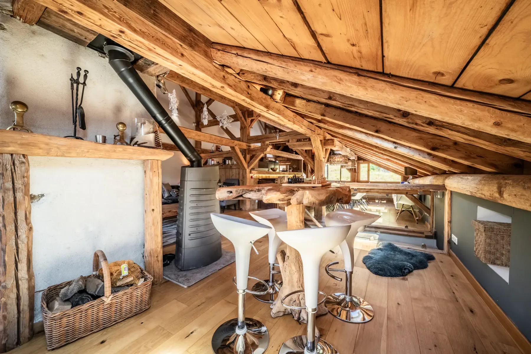 A wood-paneled loft seating area with a counter and stools.