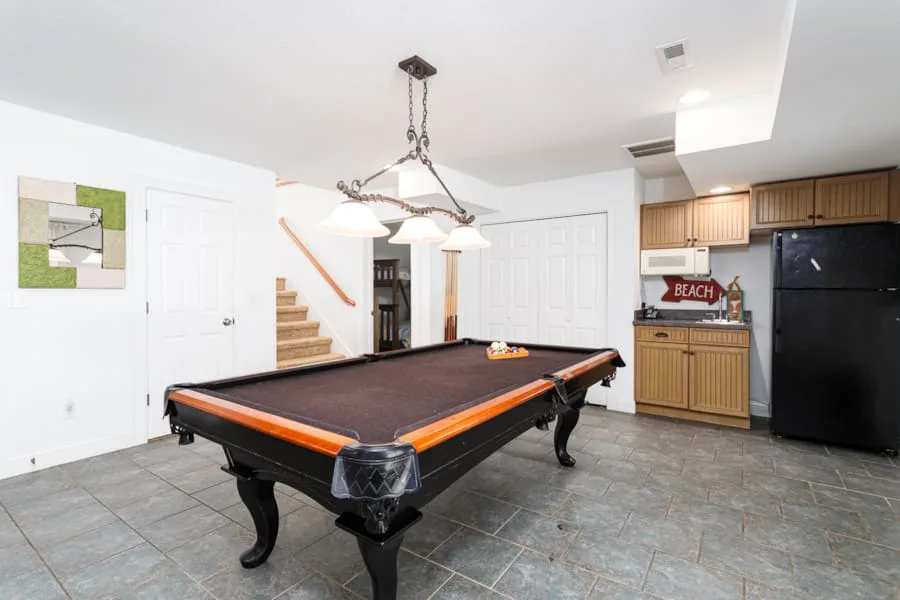 Una sala de juegos cuenta con una mesa de billar y una pequeña cocina.