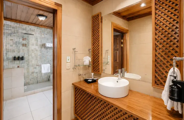 Baño de la habitación con cama queen y vista a la montaña