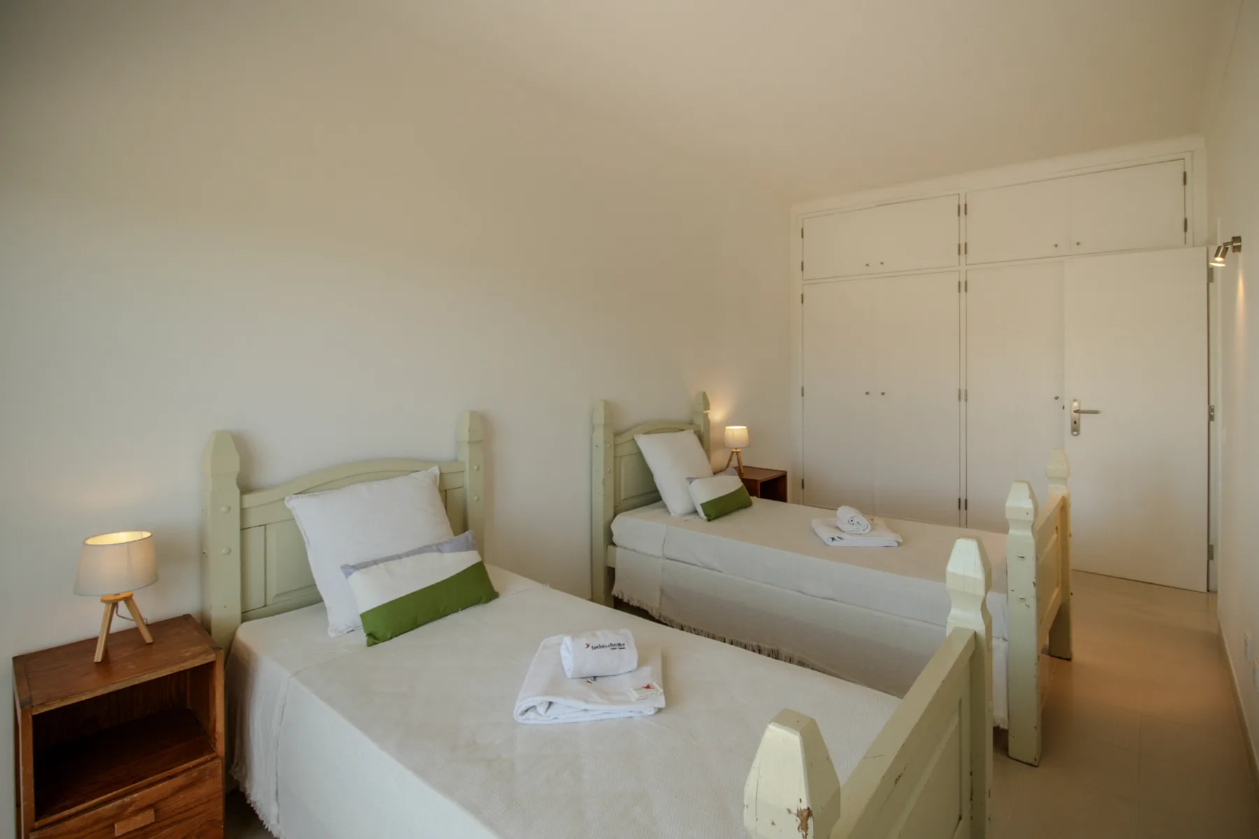 Un dormitorio con dos camas y una mesita de noche.
