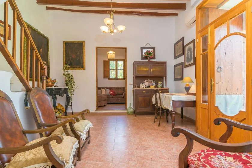 A traditional living room with wooden seating and a dining table.