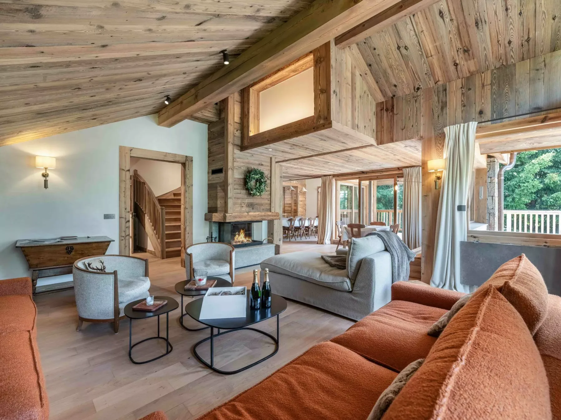 A spacious living room with wood-paneled ceilings and comfortable seating.