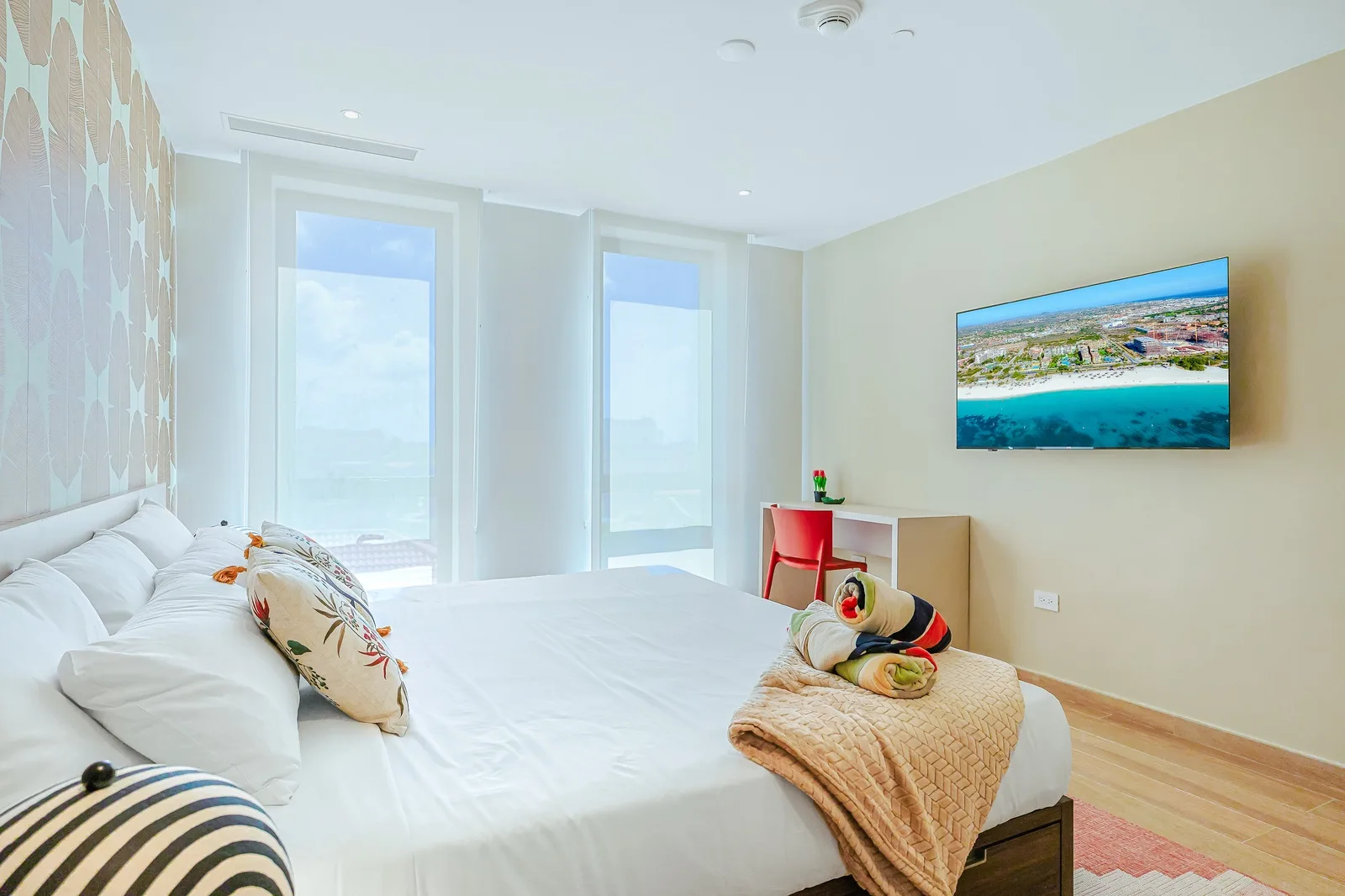 Drift into restful nights in your bright, airy bedroom. Large windows welcome natural light, and floor-to-ceiling views blur the line between indoor comfort and the calm beyond. Your peaceful retreat awaits.