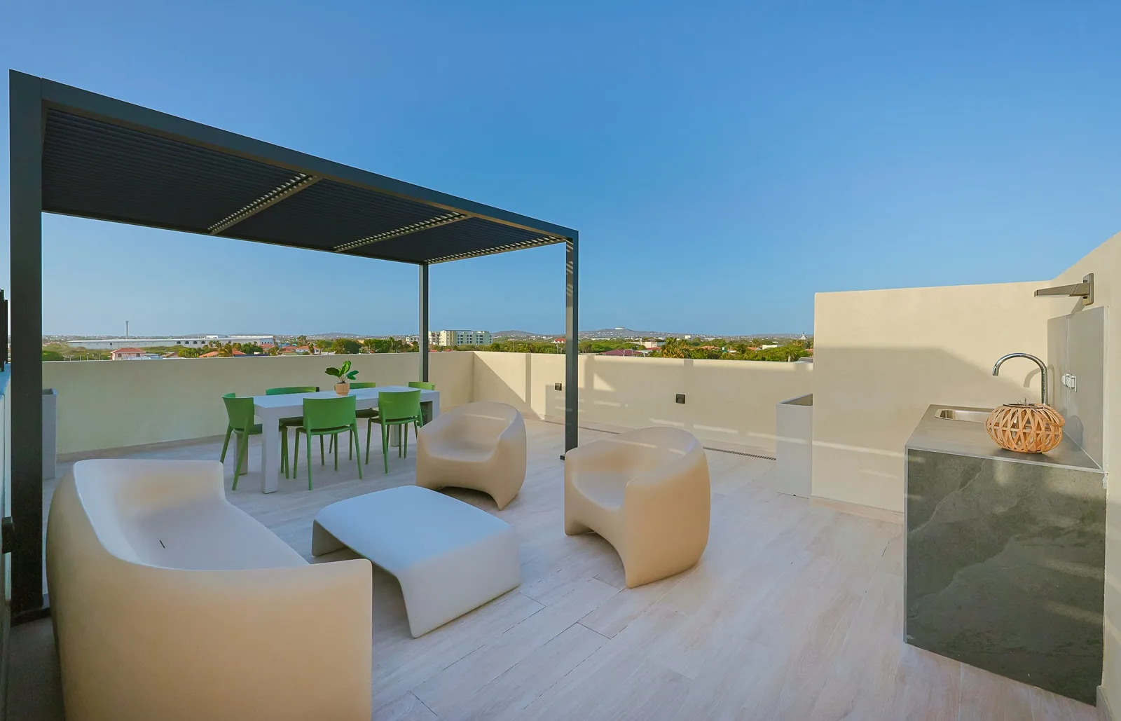 A rooftop terrace with sweeping vistas of the surrounding area, featuring modern outdoor furniture and a shaded dining space perfect for sunset gatherings.