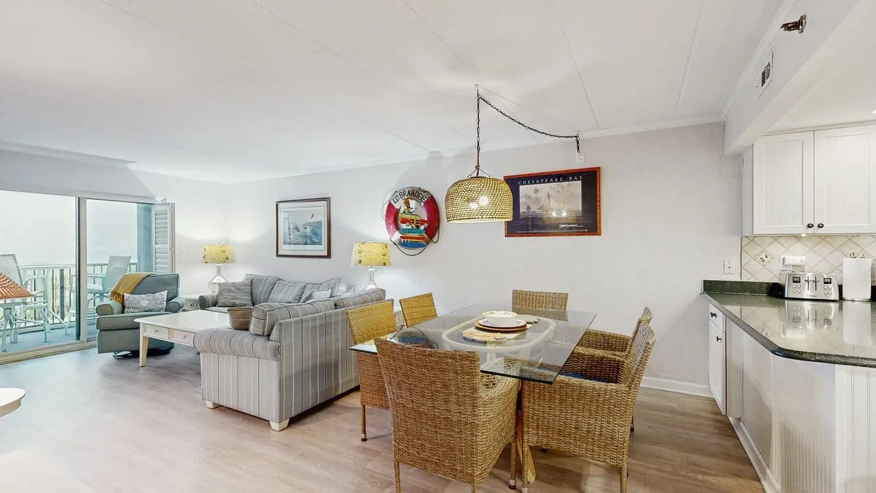 A bright living and dining area with a sectional seating area and dining table.
