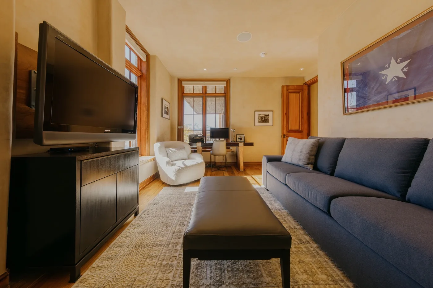 A living room with seating, a television, and a coffee table.