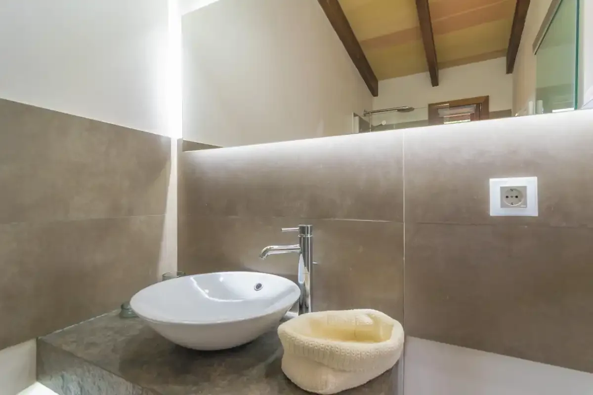 Bathroom vanity with a vessel sink and a small bowl on the counter.