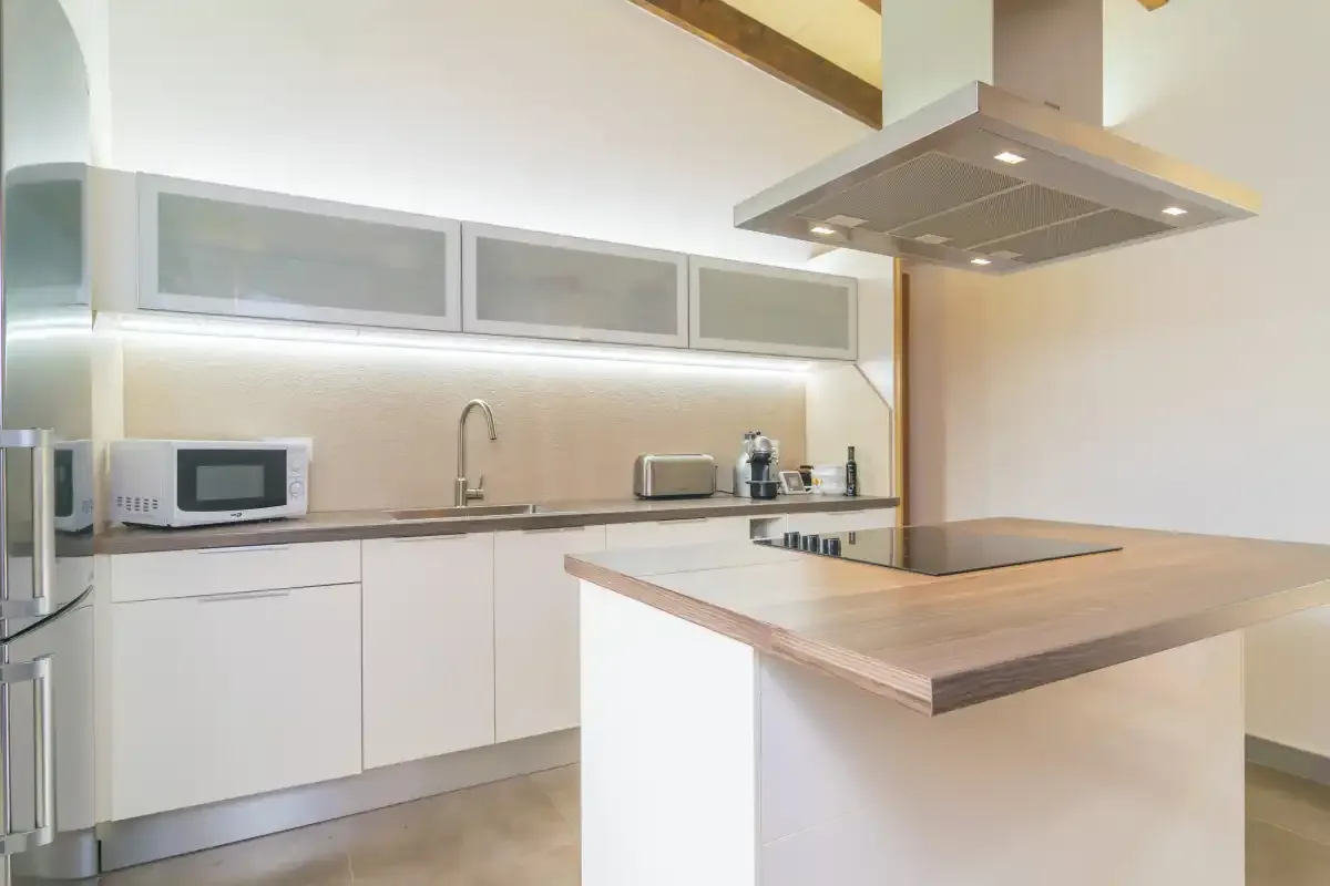 A modern kitchen with white cabinets and a central island.