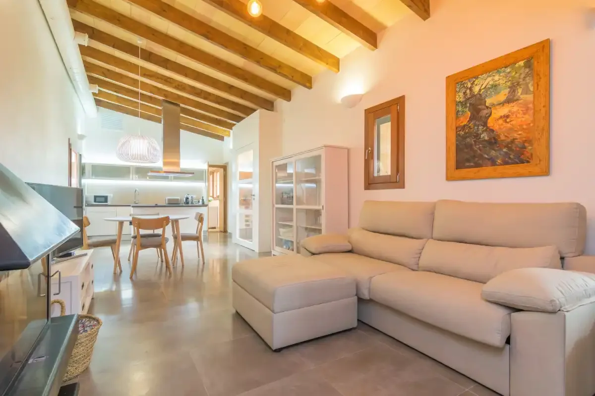 A living room with seating and an open kitchen and dining area.