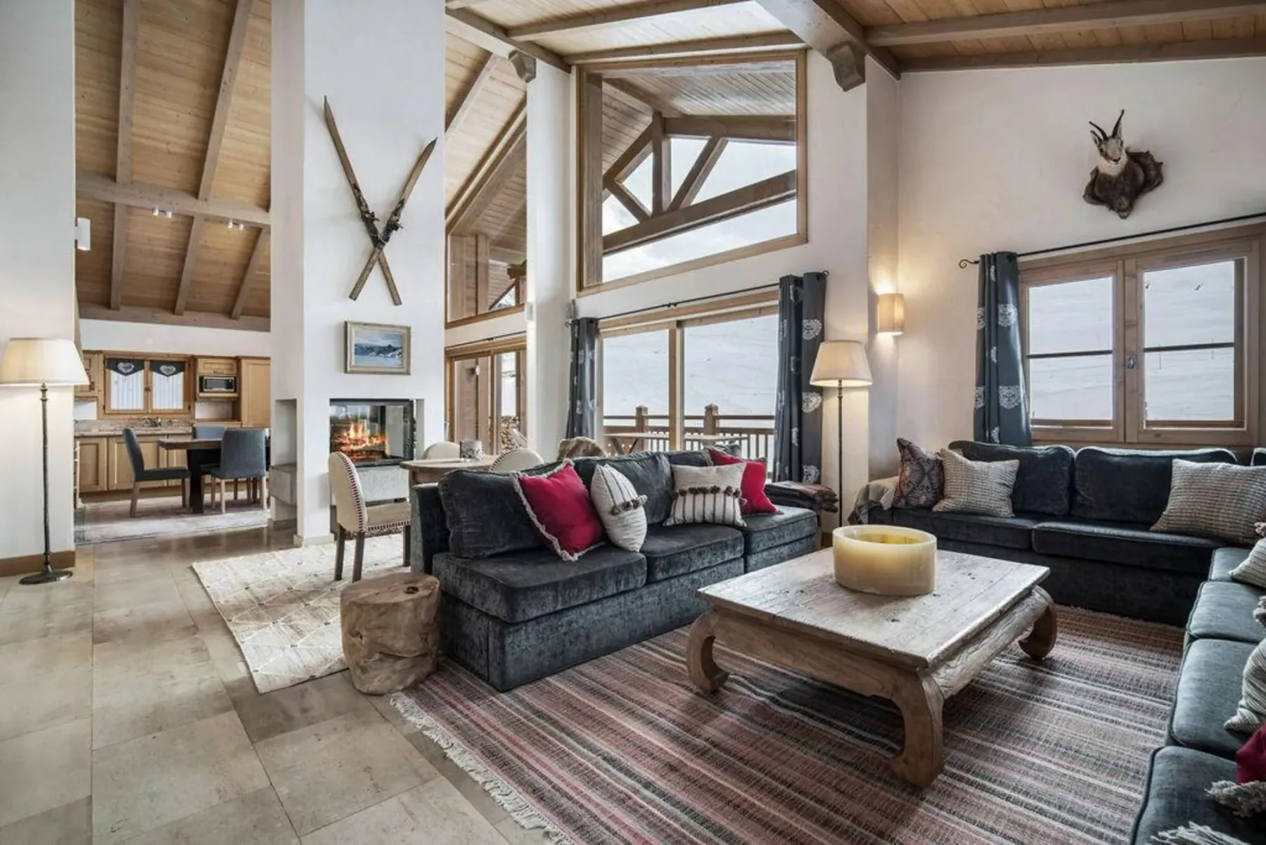 A spacious living room with seating arranged around a coffee table.