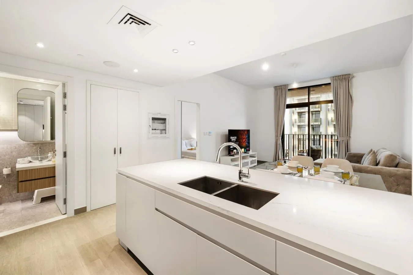 A bright open-plan kitchen and living area with a large island and dining table.