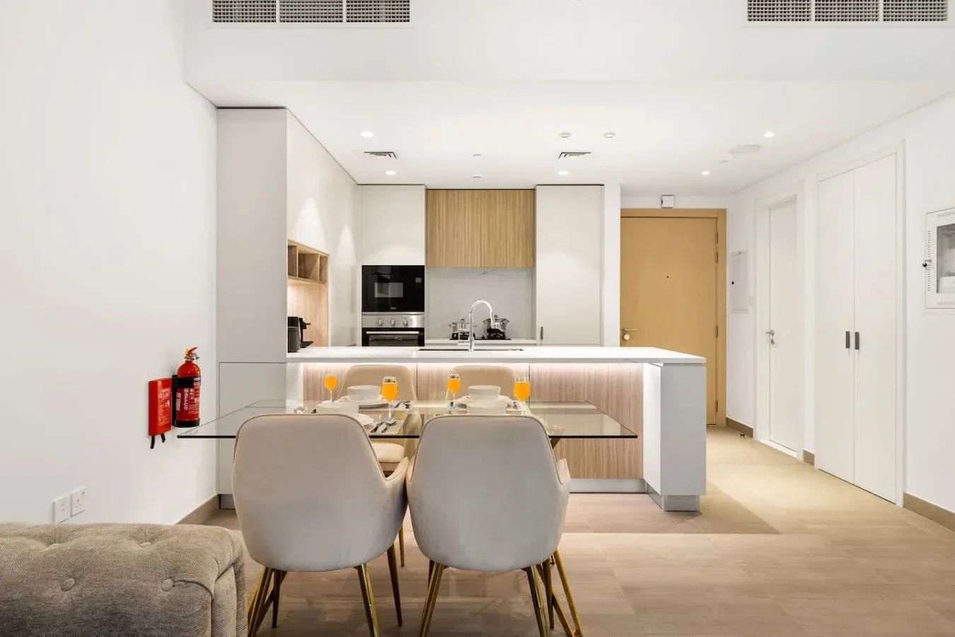 A bright open-plan kitchen and dining area with a table and seating.