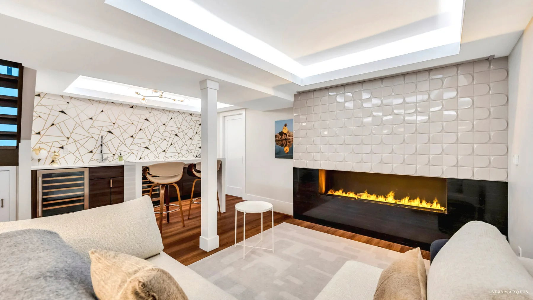 A modern living room with a fireplace and seating.