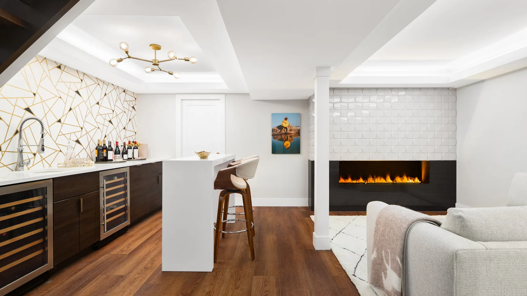 An open-plan kitchen and living area with a white island and fireplace.