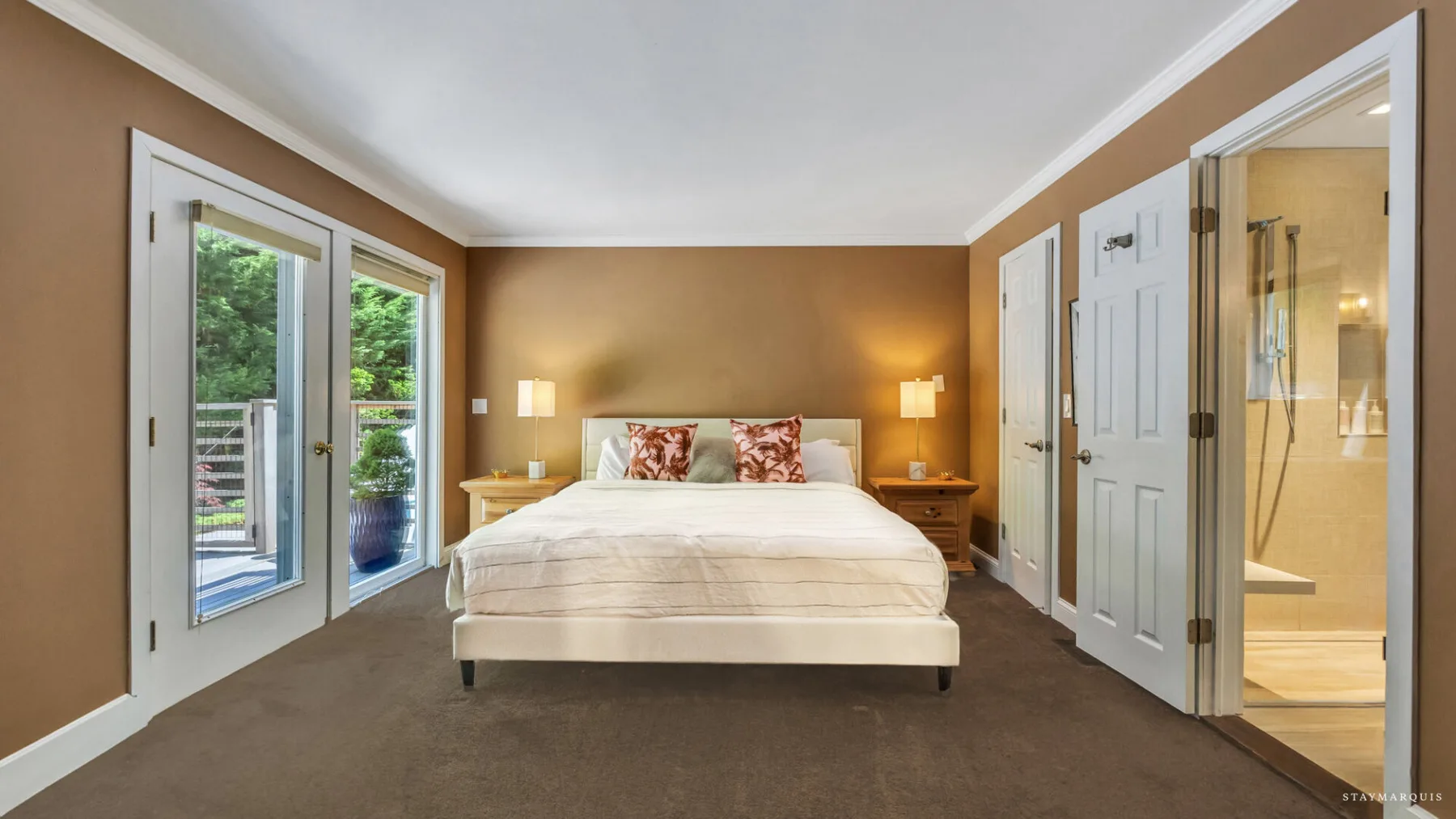 A bedroom with a bed and an open doorway to a bathroom.