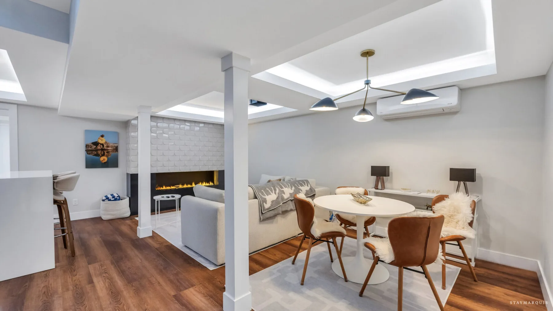 A dining and living area with a round table and seating.