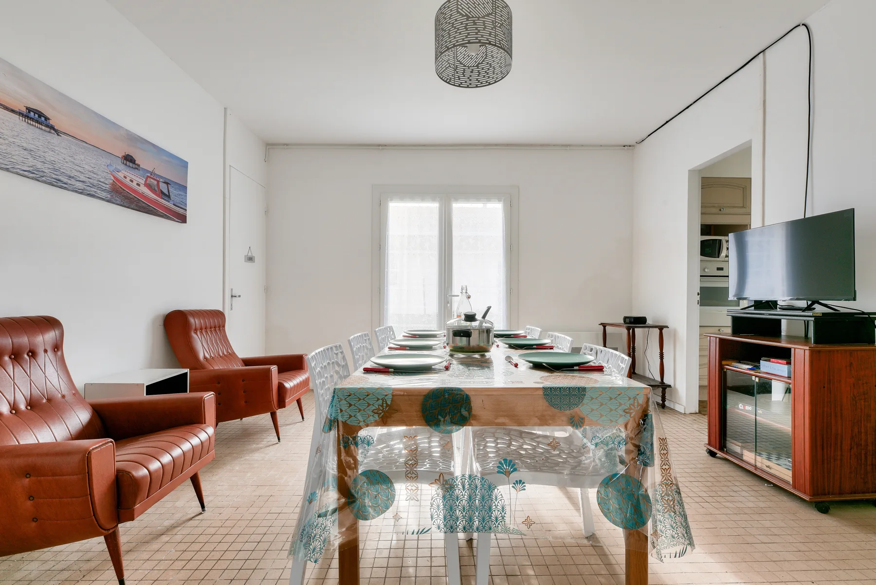 Dining area with a table set for a meal and seating.