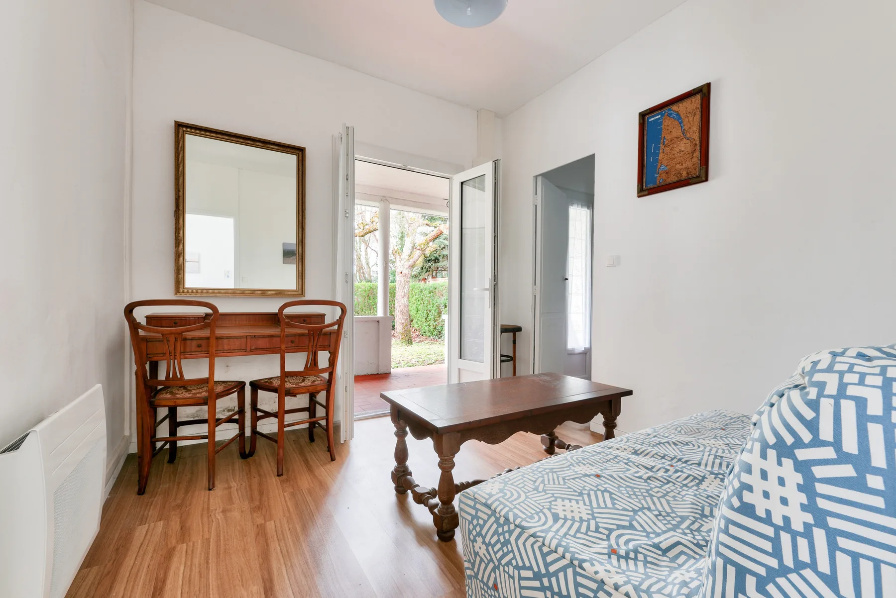 A bright living room with seating, a coffee table, and a dining area.