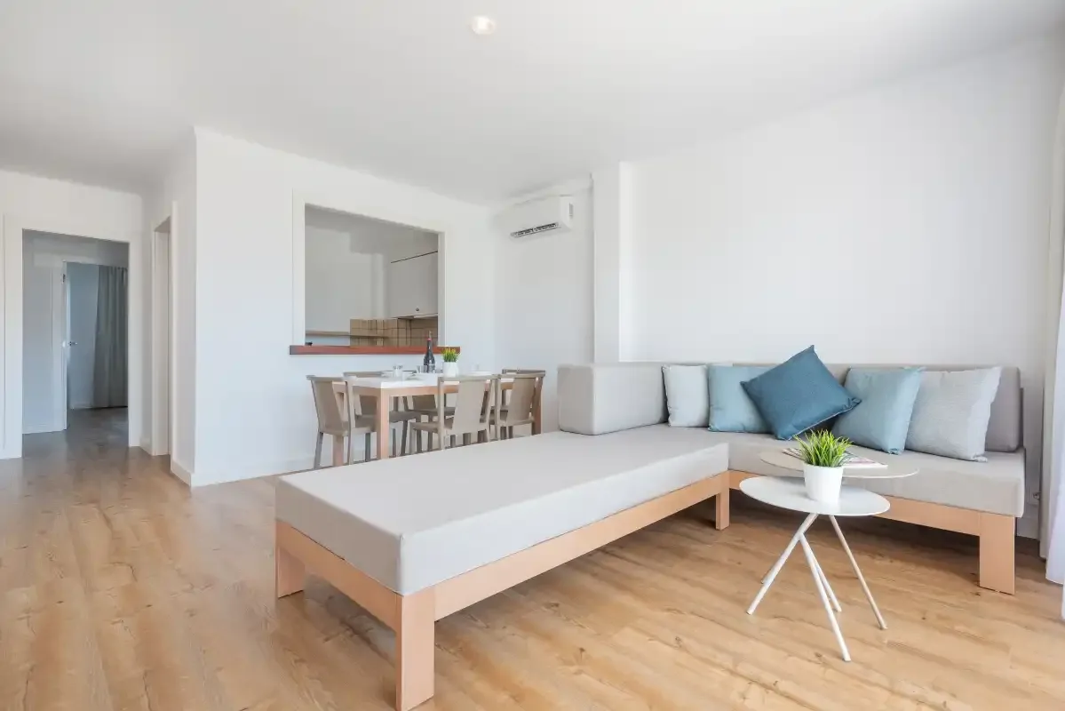 A bright living room with an L-shaped seating area and a low table.
