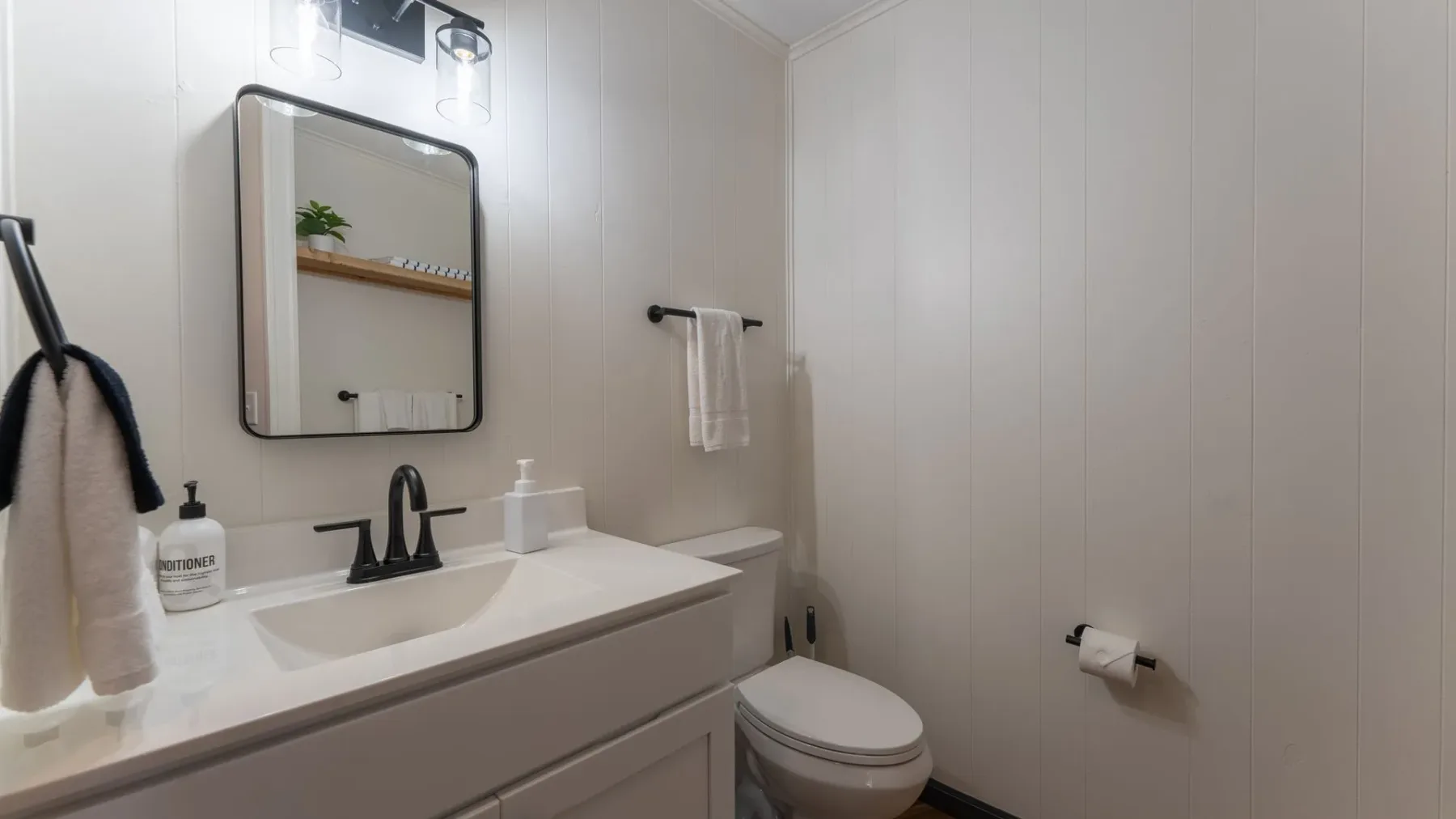 Bathroom with vanity, mirror and towel bar
