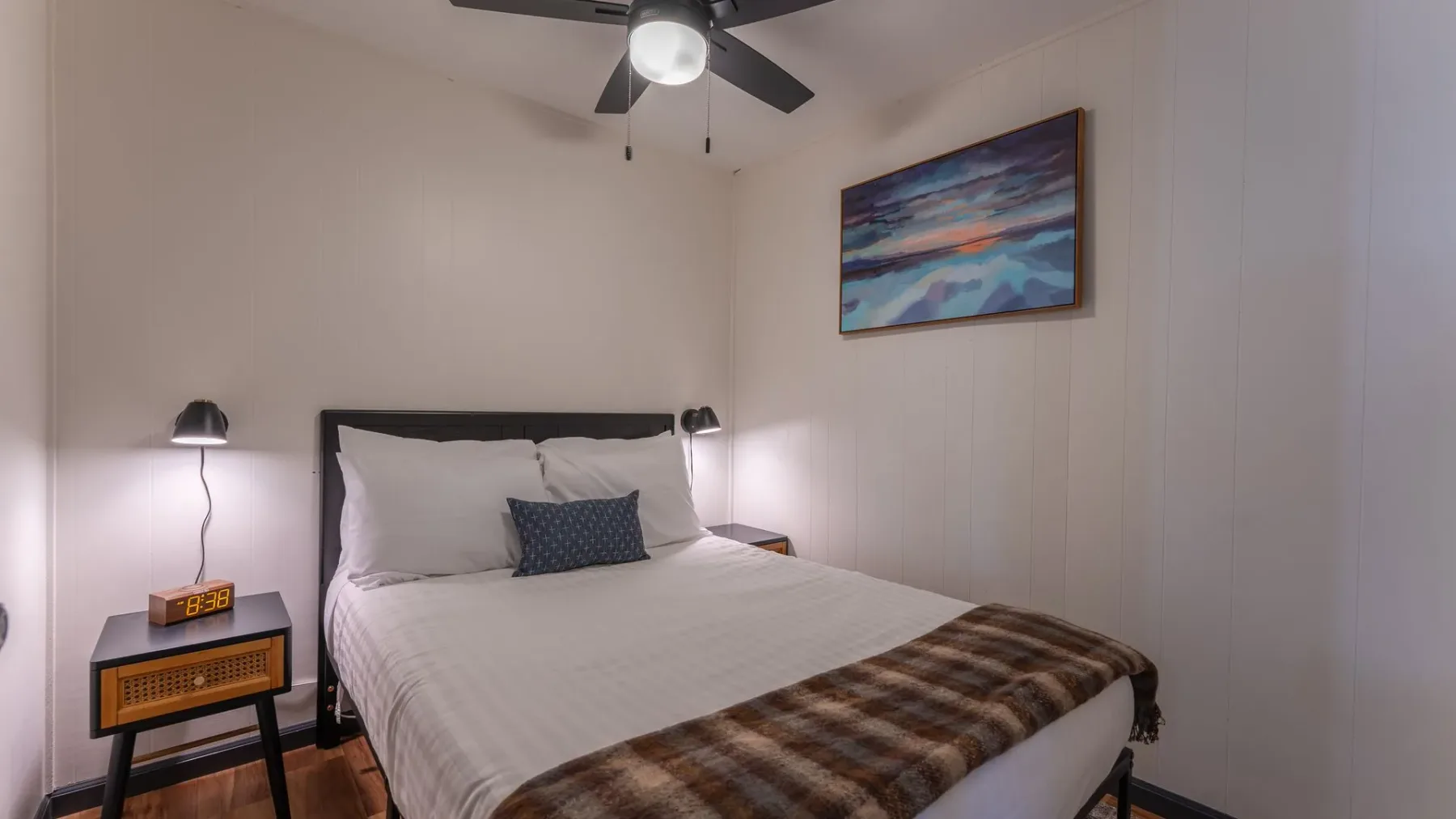 Bedroom with white bed and bedside lamp