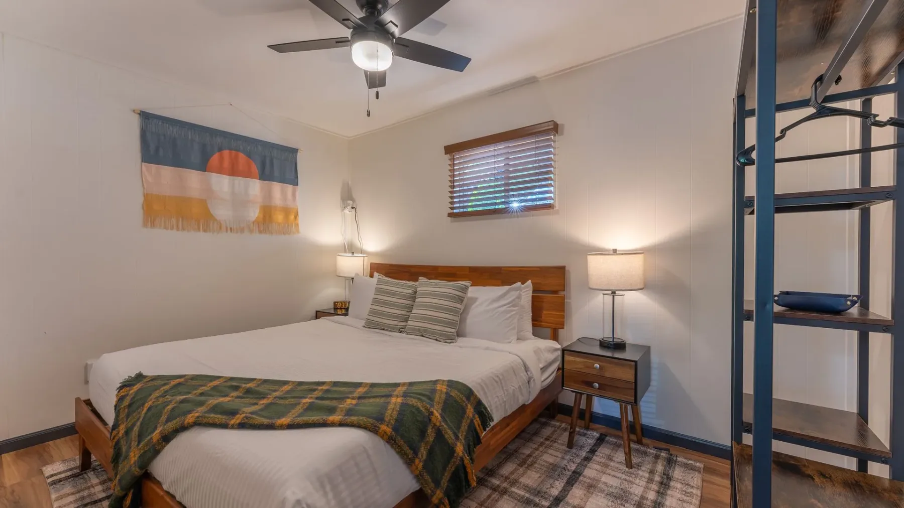 Bedroom with ceiling fan and blue spiral staircase