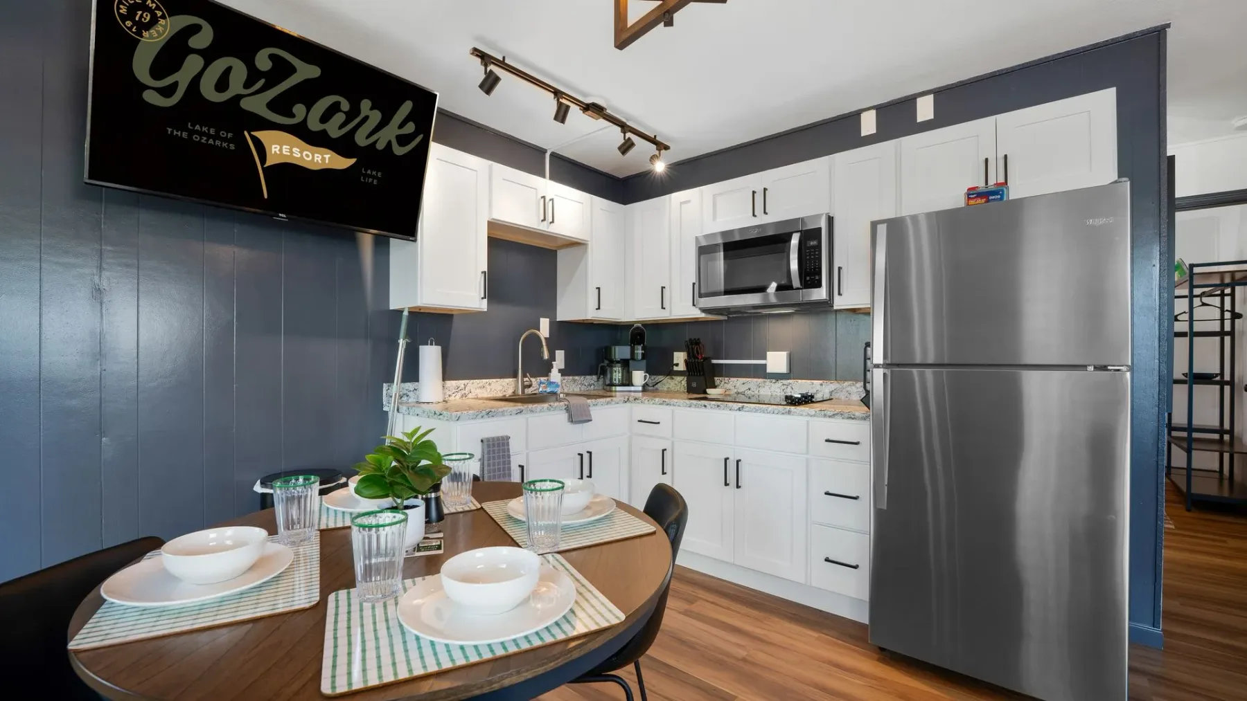 Kitchen with stainless appliances and dining table