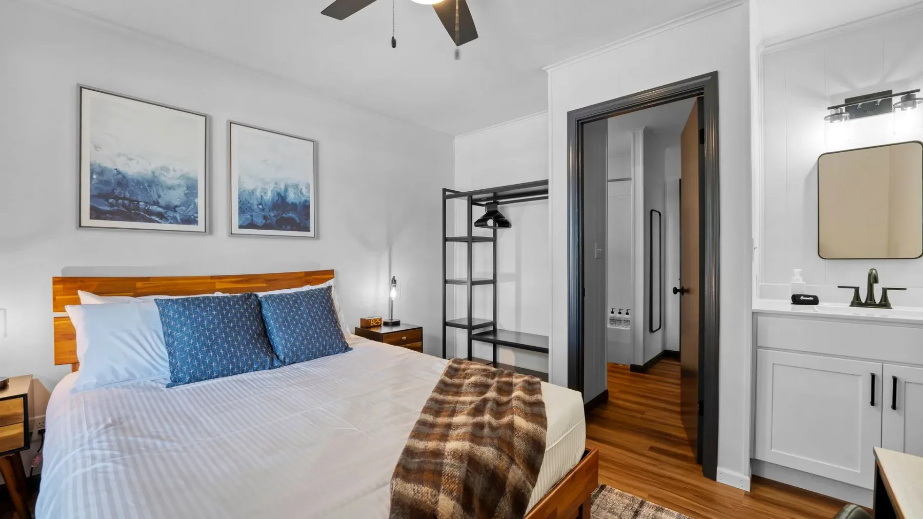 Bedroom with wooden bed and vanity mirror