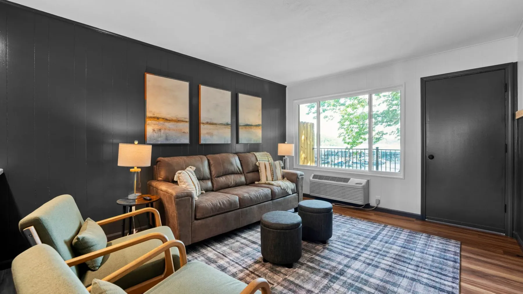 Living room with sofa, armchair and window view