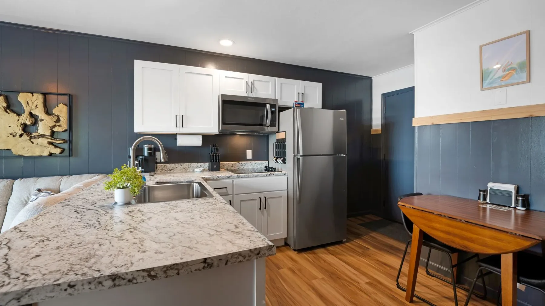Kitchen with white cabinets and granite island
