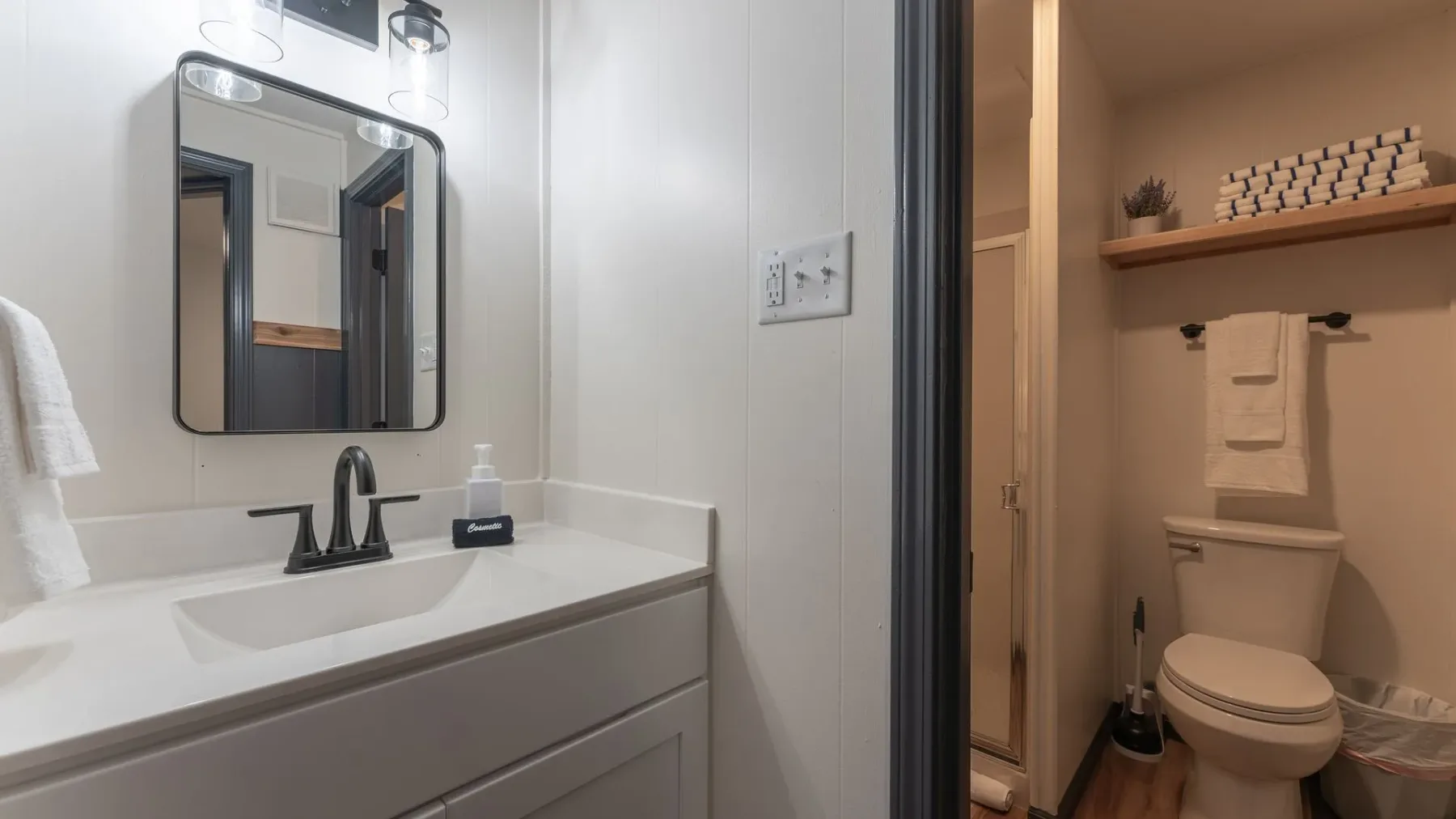 Bathroom vanity and adjoining toilet alcove