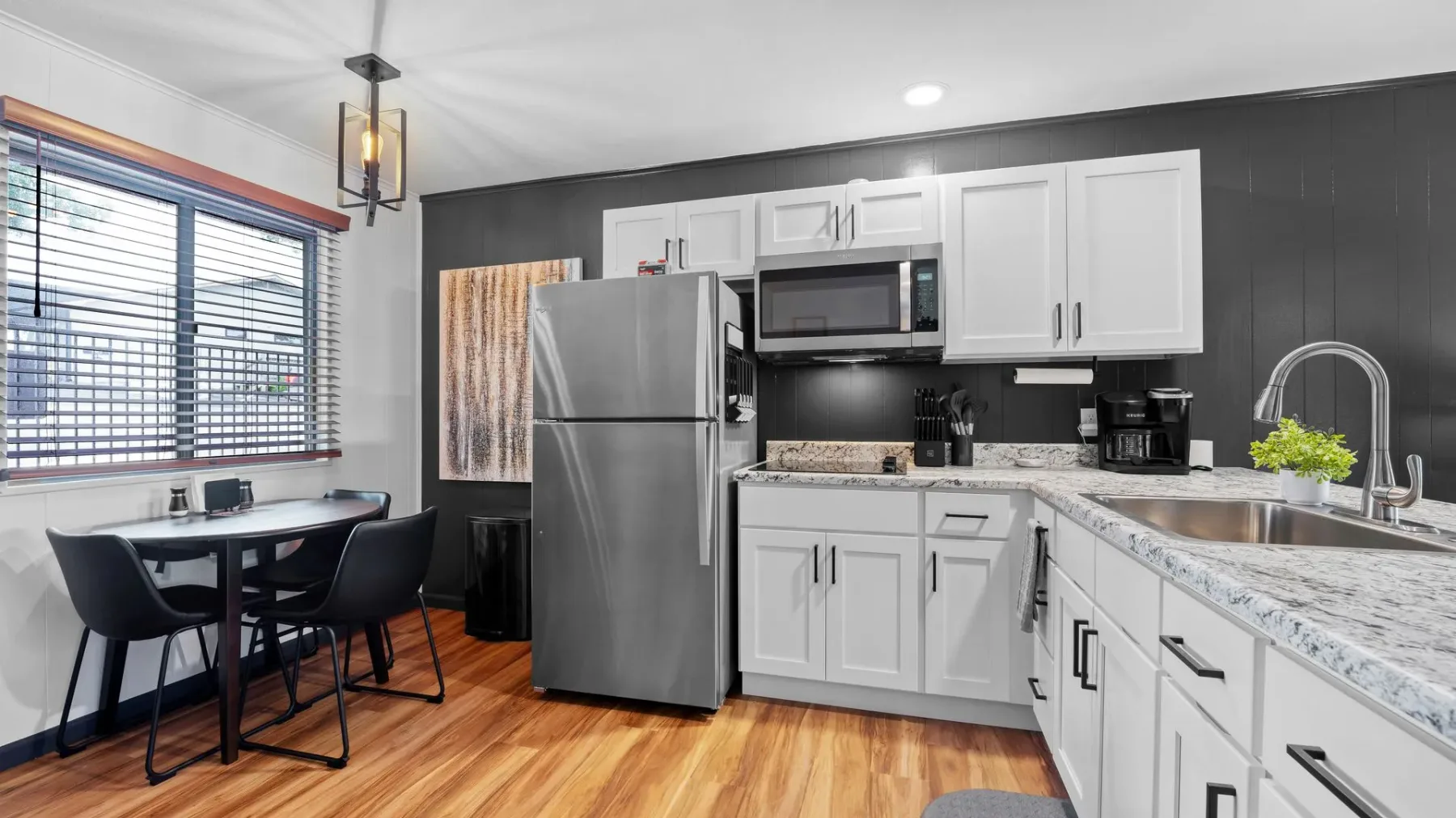 Kitchen with stainless appliances and white cabinets