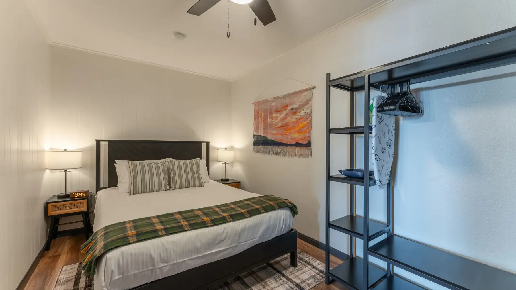 Bedroom with bed, bedside lamps and ceiling fan