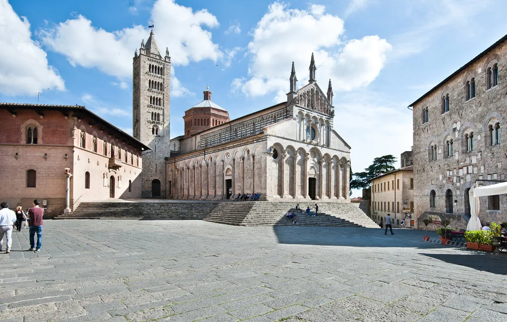 A historic cathedral overlooks a broad stone-paved square.