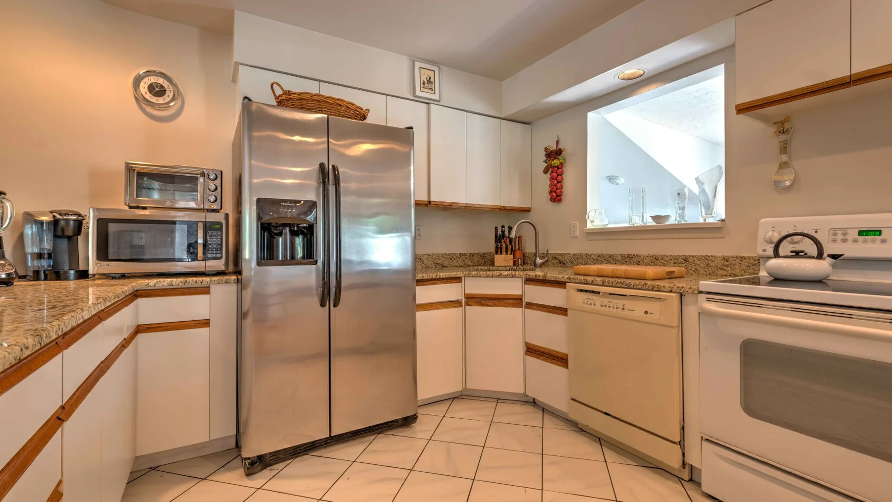 A bright kitchen with stainless steel appliances and light-colored cabinetry.