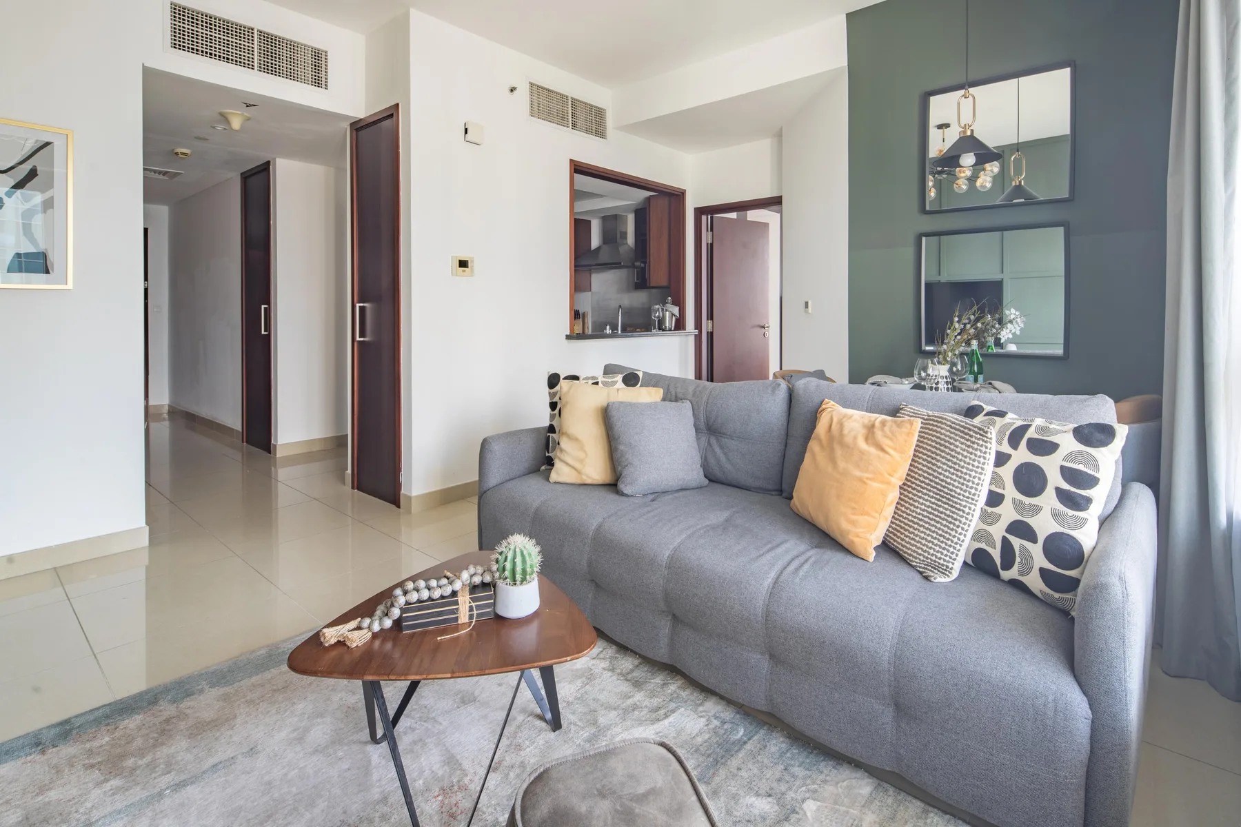 A living room with a gray sofa and a small coffee table.