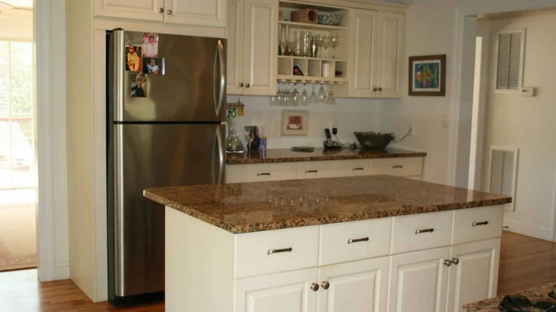 A bright kitchen with white cabinets and a large central island.
