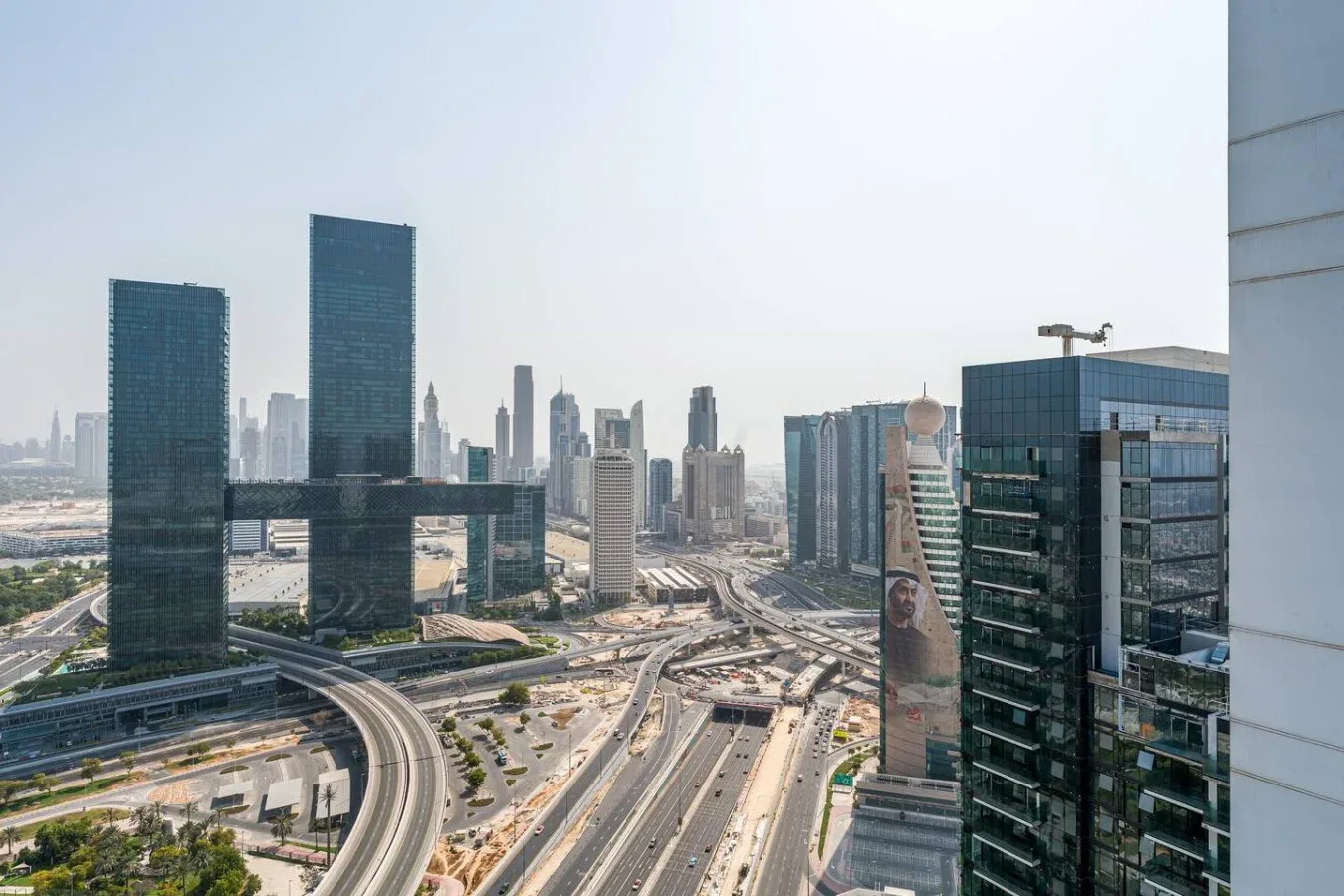 City skyline with modern high-rise buildings and elevated roads.